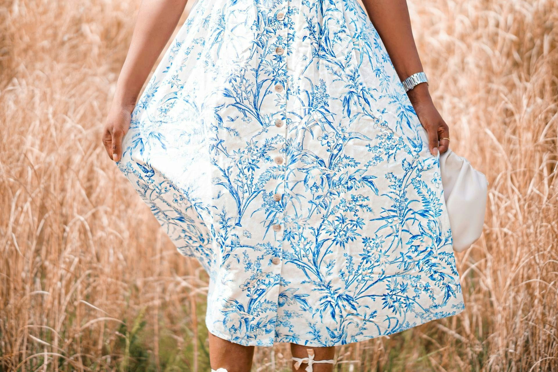 Close up of a white and blue dress in a field 