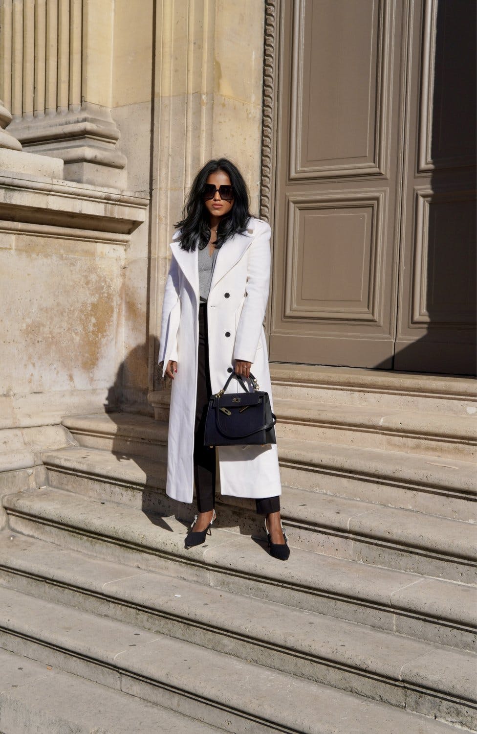 Sachini wearing a white Karen Millen coat in Paris