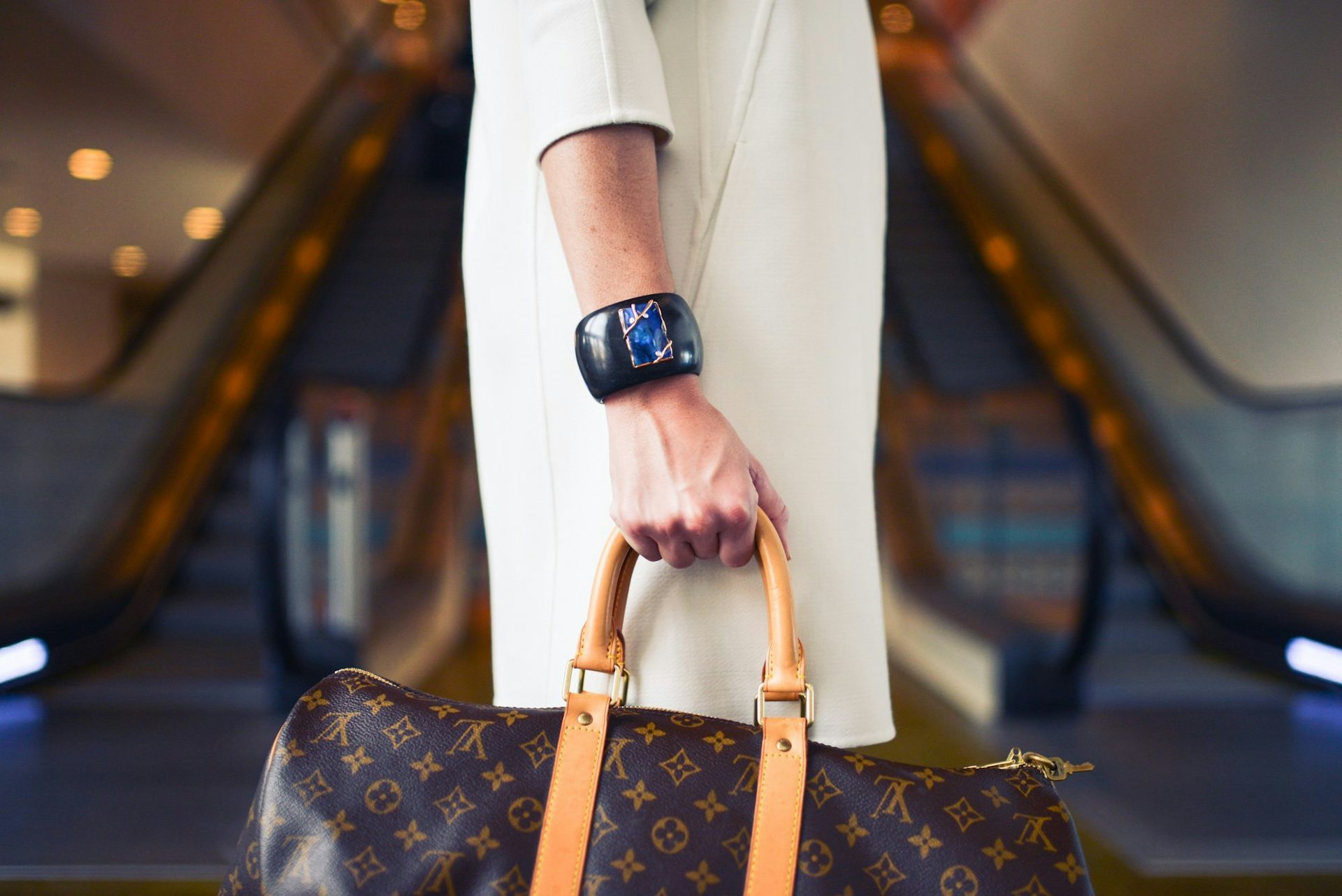 model wearing a watch holding a Louis Vuitton bag